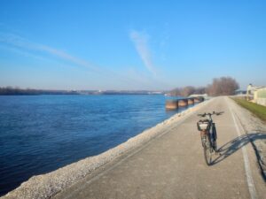 Great River Trail in IL, with a standing bicycle on a trail next to a river,