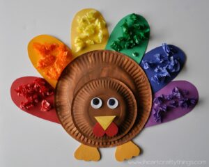hand crafted multi colored feathered turkey made out of paper plates