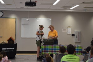 Photo from June 3, 2023. Big Run Wolf Ranch worker holding a skunk