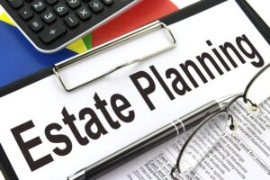 estate planning flyer on a mini clipboard next to a laptop